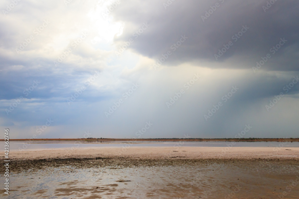 Dark storm clouds over a salt lake before a rain Dark storm clouds over a salt lake before a rain