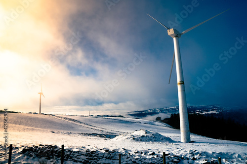 Wind turbine during Morning sunrise in a winter misty wonderland south wales uk