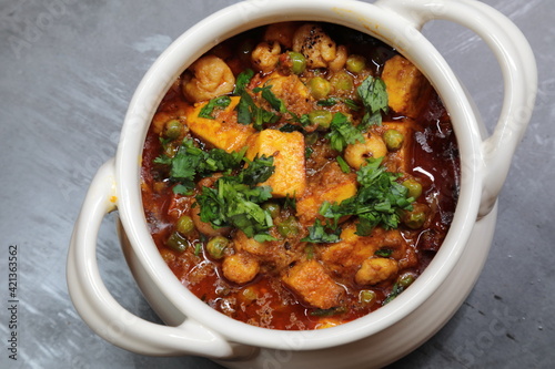 A spicy Makhana Paneer curry in a bowl. photo