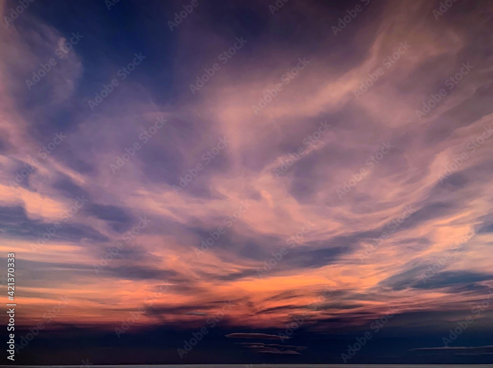 Fantastic sunset clouds in night sky. Purple magical cloudscape. Incredible heaven spectacle.