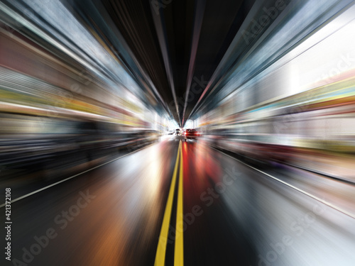 Motion blur view of wet streets below elevated commuter train lines in downtown Philadelphia, Pennsylvania.