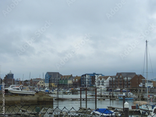 View of the buildings by the canal in the town and the marina with boats