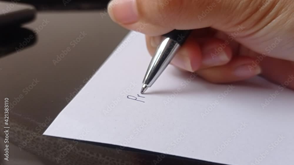 writing a random thought with a pen on a blank paper