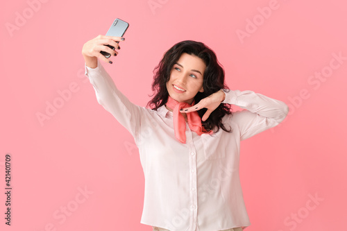 Beautiful young woman takin...