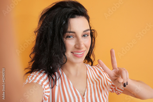 Beautiful young woman takin...