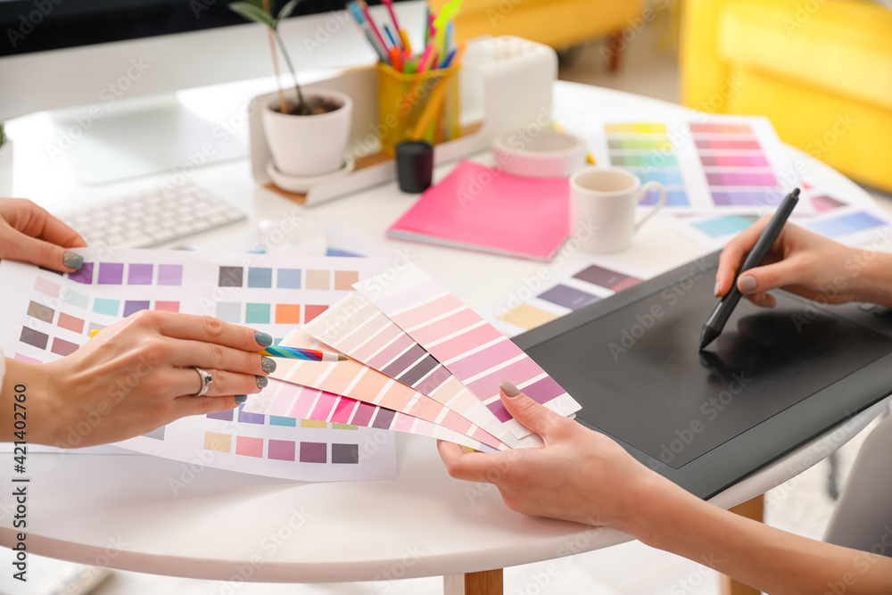 Graphic designer with colleague working in office