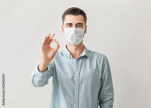 Young man in medical mask s...