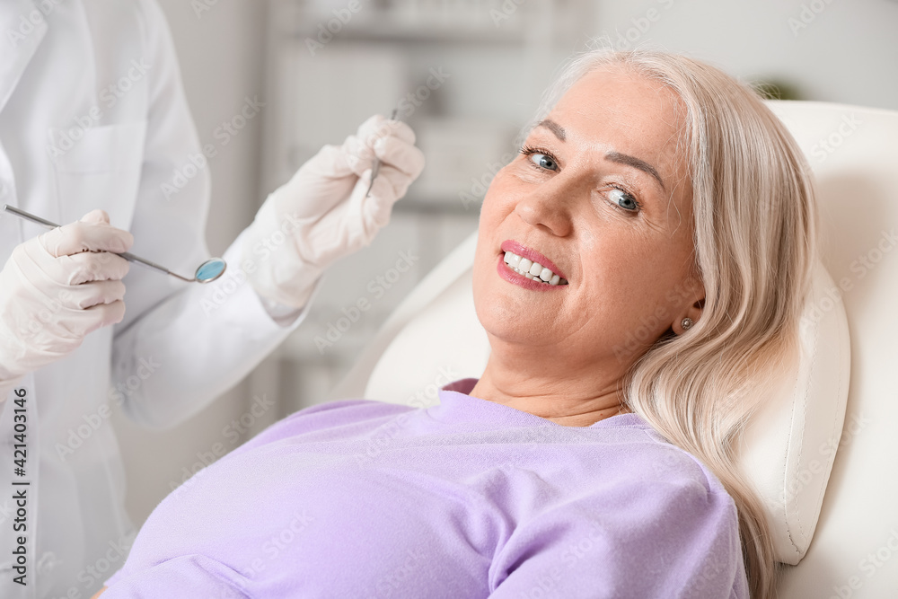 Mature woman visiting dentist in clinic Mature woman visiting dentist in clinic