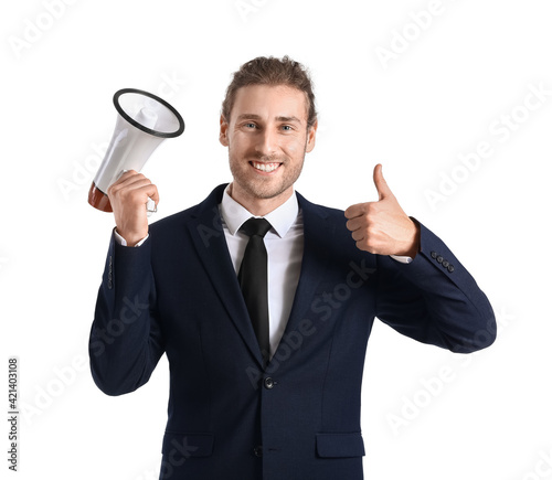 Young businessman with megaphone showing thumb-up gesture on white background