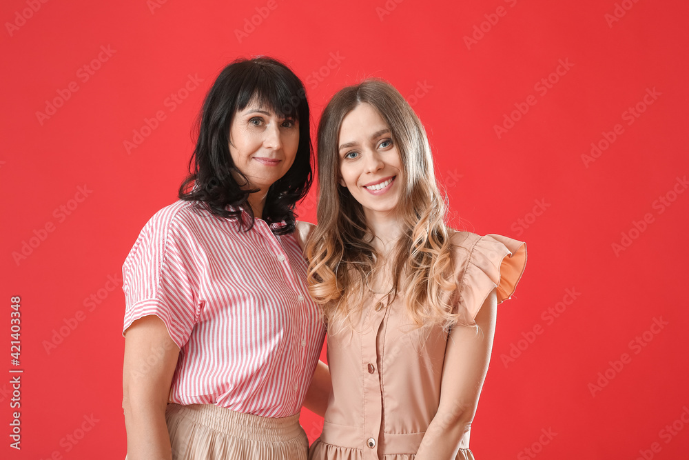 Young woman and her mother on color background Young woman and her mother on color background