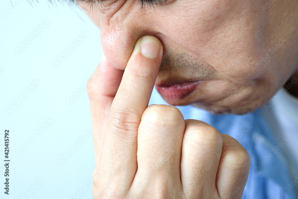 The man covered the nose, dodging the bad smell. The man covered the nose, dodging the bad smell.