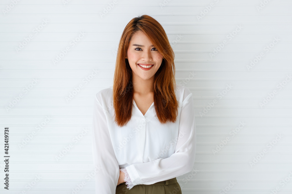 Horizontal half-body portrait shot of beautiful cute smiling young adult Asian woman in formal long sleeve white shirt looking at the camera posing on white background Horizontal half-body portrait shot of beautiful cute smiling young adult Asian woman in formal long sleeve white shirt looking at the camera posing on white background