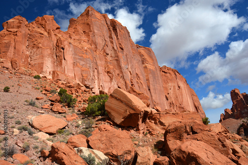 spectacular view of eroded cliffs and red rocks along the chimney rock trail on a sunny autumn day in capitol reef national park, utah