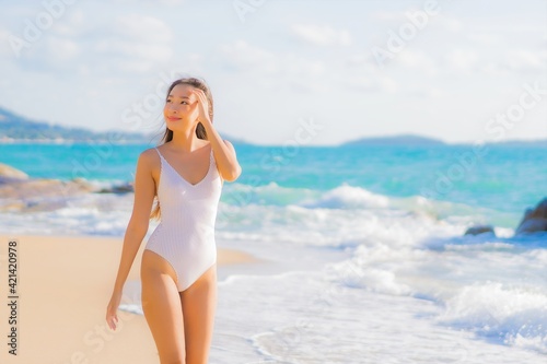 Portrait beautiful young asian woman relax smile leisure around beach sea ocean