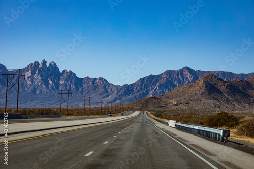 open high way in New Mexico with the Organ Mountains or Las Cruces on the background. 