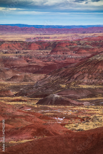 dramatic landscape photo of the Painted Desert in the Petrified Forest National Park in Arizona. The Painted Desert is known for its brilliant and varied colors.