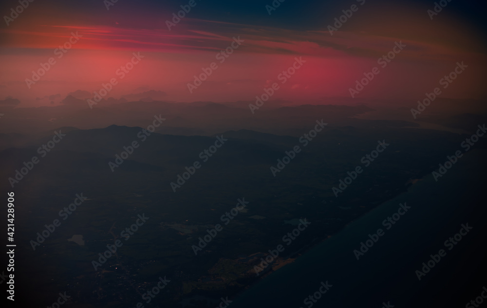 Blurred abstract background from high angle from plane window, overlooking the scenery below (river, mountain, tree).