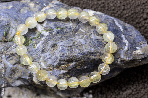 Golden Rutile Quartz , Golden rutilated quartz bracelet, Selective focus at the front of the bracelet and leaving the back of it blurry.