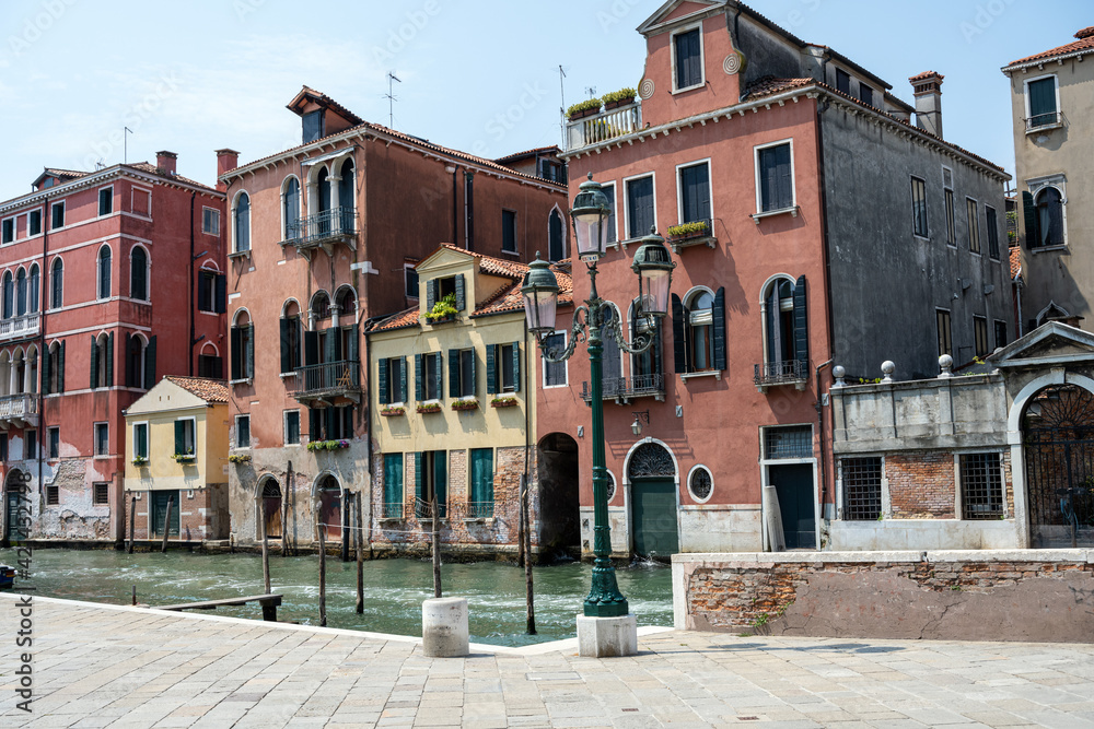 Beautiful old houses and one of the famous channels seen in Venice, Italy