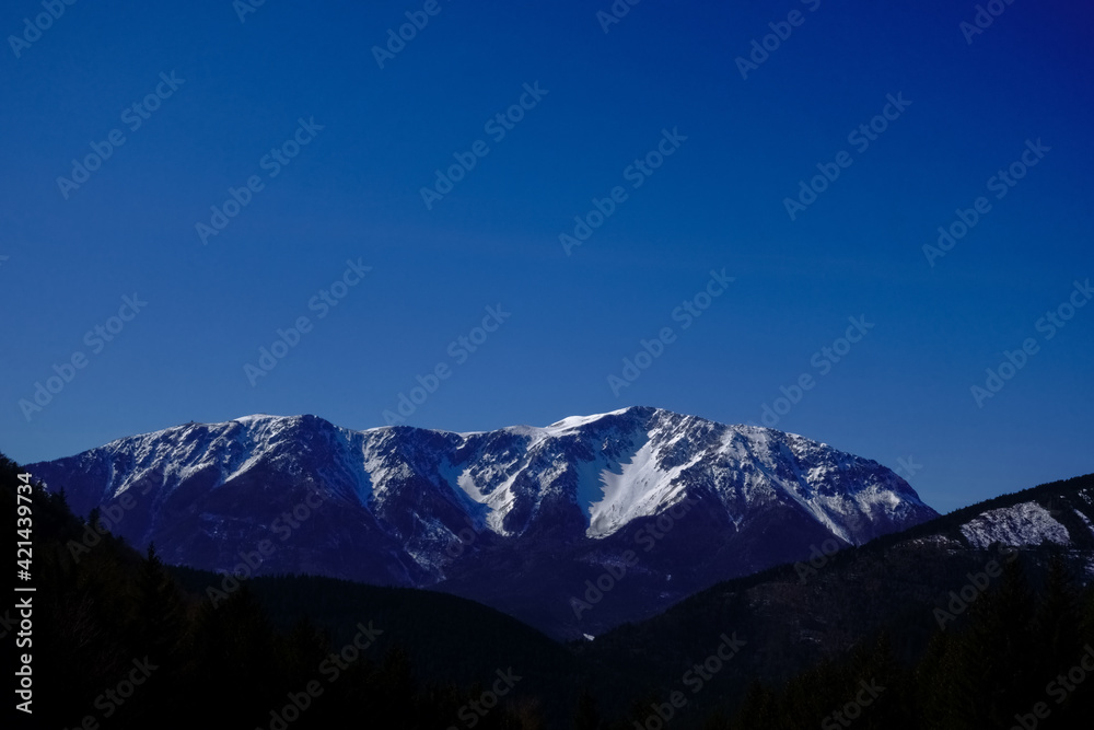 snow on the mountains and blue sky in the spring