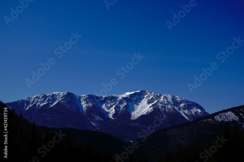 snow on the mountains and blue sky in the spring