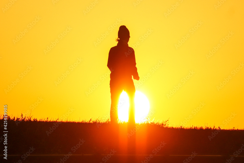 Silhouette of a person floating in the morning sun