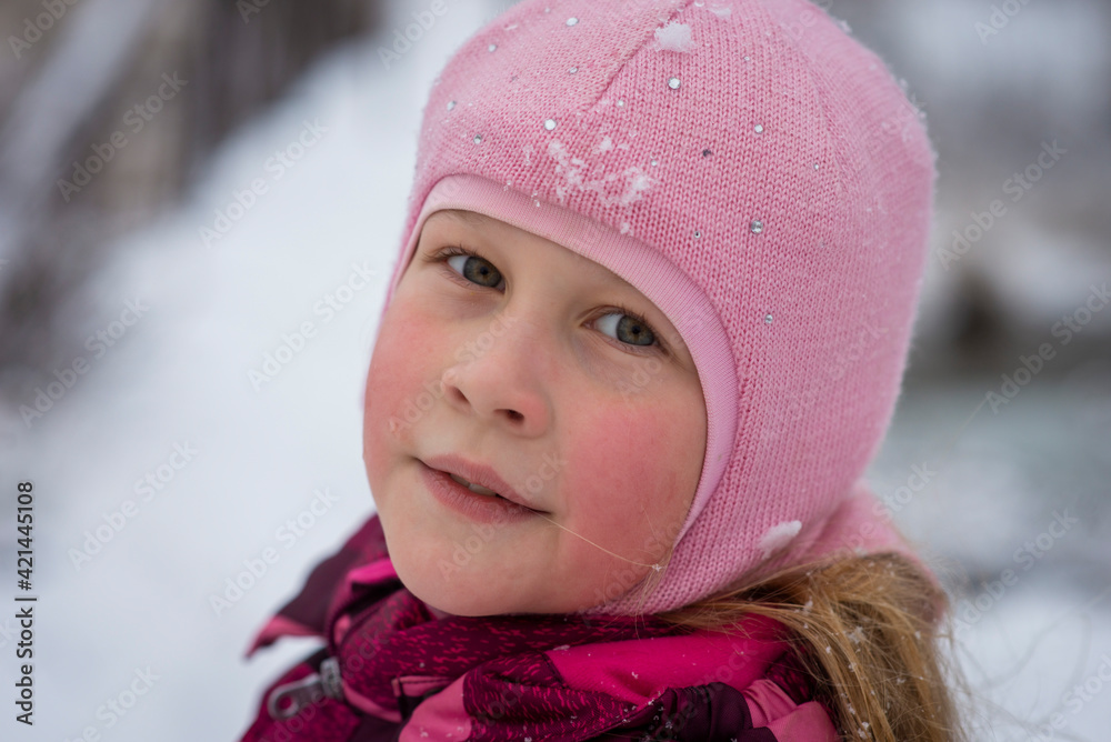 girl in a pink jacket in winter, selective focus
