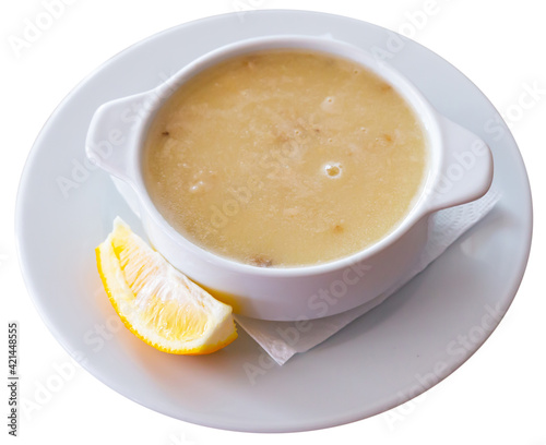 Homemade turkish soup Tavuk Suyu corbasi in a white ceramic soup plate. Isolated over white background