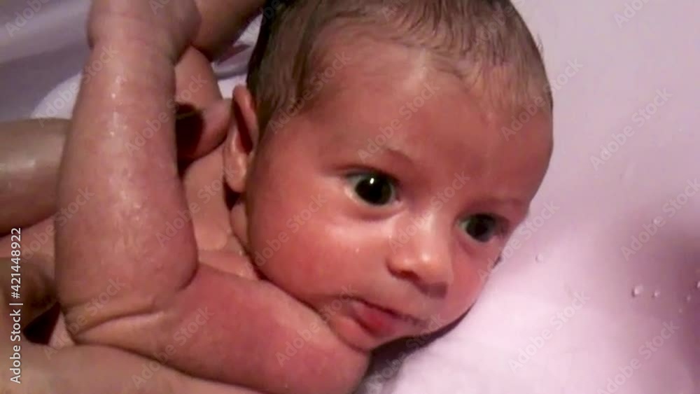 Young baby making her first bath at home Young baby making her first bath at home