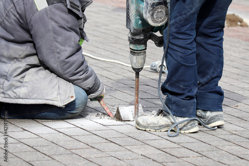Canvas Print Workers repair the road surface with a jackhammer