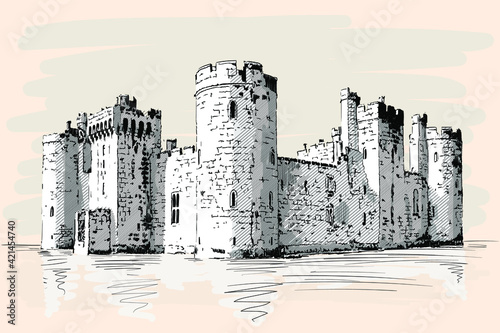 Medieval stone castle with towers and arches on the sea shore.