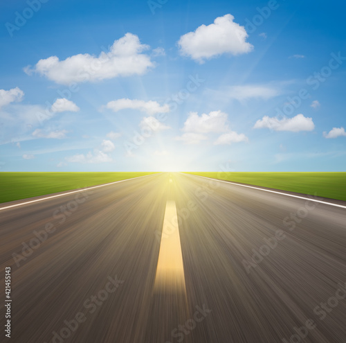 Motion blur of highway in perspective and nature landscape. Consist of long straight line on asphalt road or way and empty horizon sky background at outdoor. Concept for drive car, race, speed, fast.