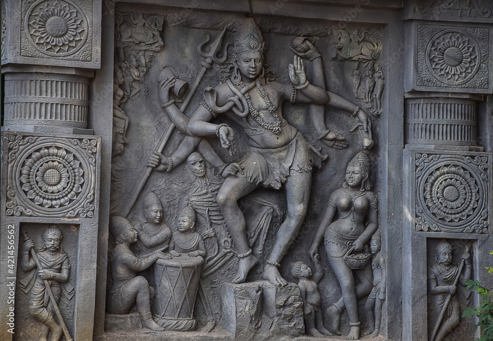 Stock photo of intricate sculpture of Indian lord shiva, carved out of stone in ancient hindu temple at Kolhapur city Maharashtra India. focus on object.
