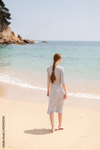 woman walking on the beach spain © Maksim Rodriges