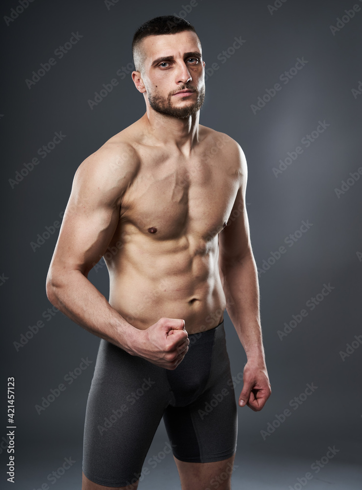 MMA fighter posing on gray MMA fighter posing on gray