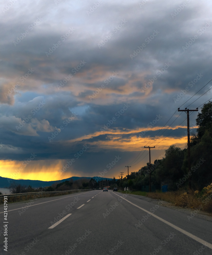 Empty countryside road during overcast weather with clouds.