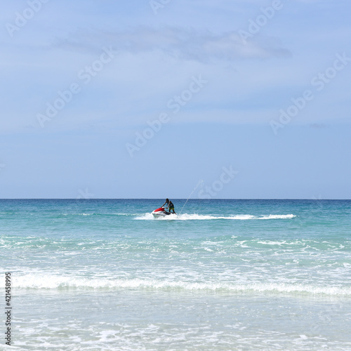 Unrecognizable man on jet ski in the ocean, summer holidays activities. © 22Imagesstudio