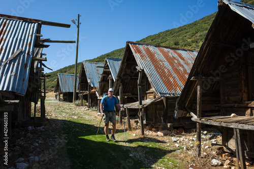 Hiking Lycian way. Man is trekking next to Traditional wooden depots in Bezirgan highlands on Lycian Way trail, Outdoor activity in Turkey photo