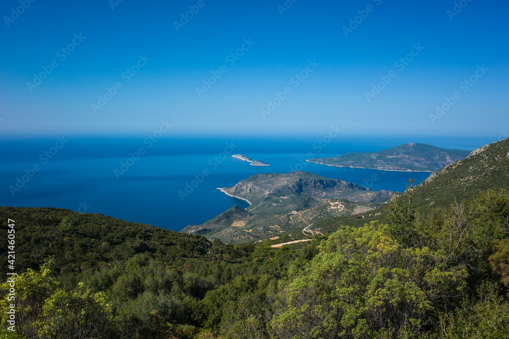View of Mediterranean sea coast from Lycian Way hiking trail high above Kalkan, Nature of Turkey. Horizon line between blue ocean and sky seen from green mountain