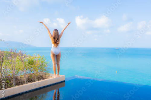 Portrait beautiful young asian woman relax smile leisure around outdoor swimming pool