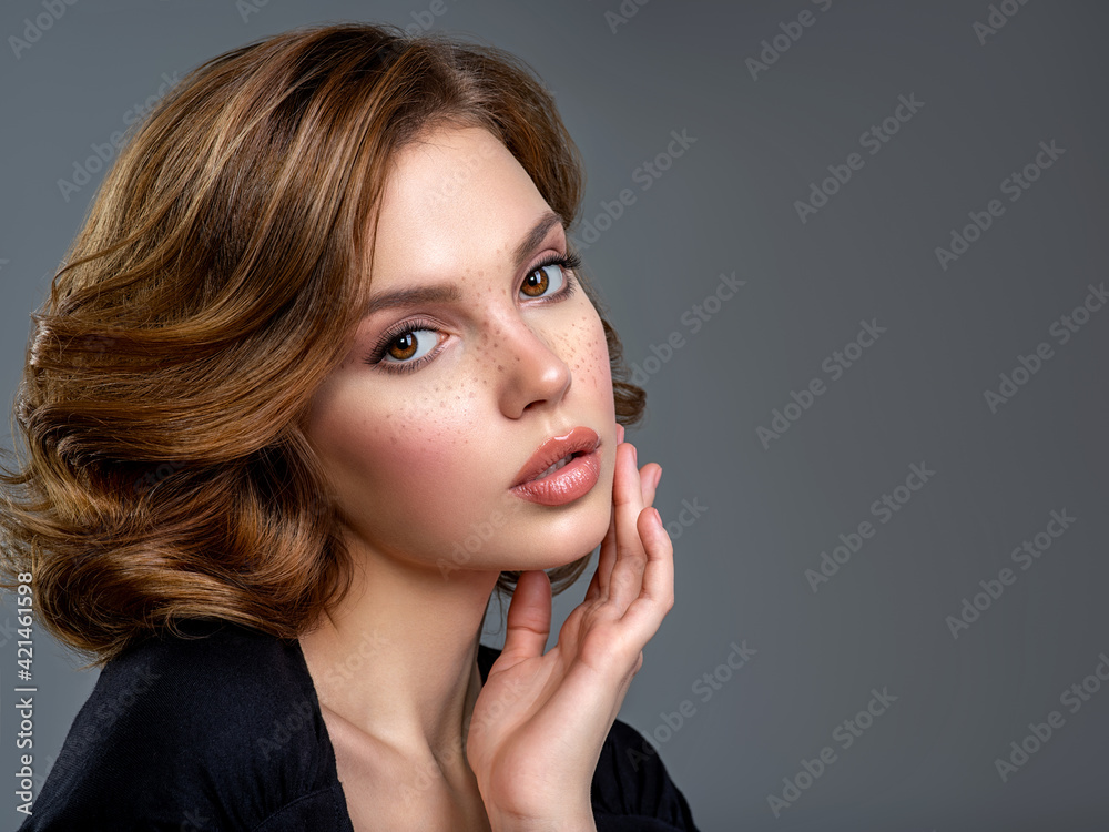 Beautiful brown haired with stylish short hairstyle. Woman with a curly hair. Beautiful young woman with freckles on face. Closeup portrait of an attractive girl with a brown makeup. Beautiful brown haired with stylish short hairstyle. Woman with a curly hair. Beautiful young woman with freckles on face. Closeup portrait of an attractive girl with a brown makeup.