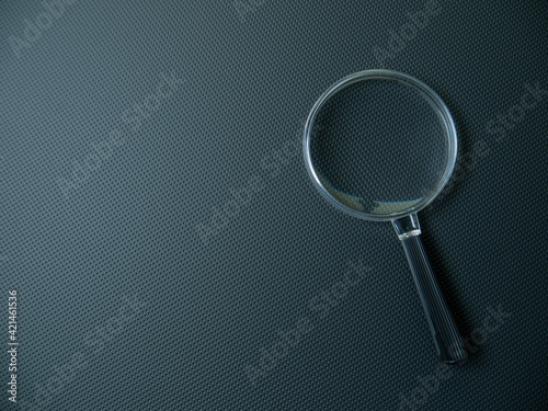 The Magnifying glass on black background for search concept