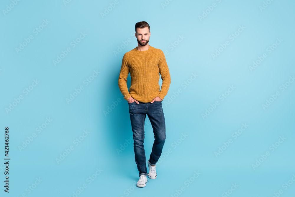 Full size photo of young handsome serious businessman wear knitted yellow jumper isolated on blue color background