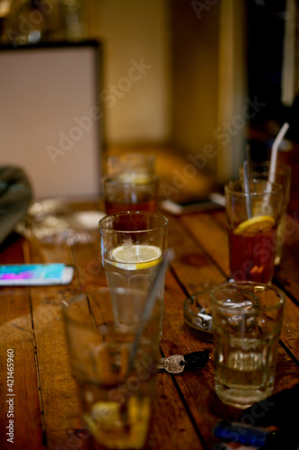 glass of lemon tea and cocktail on table