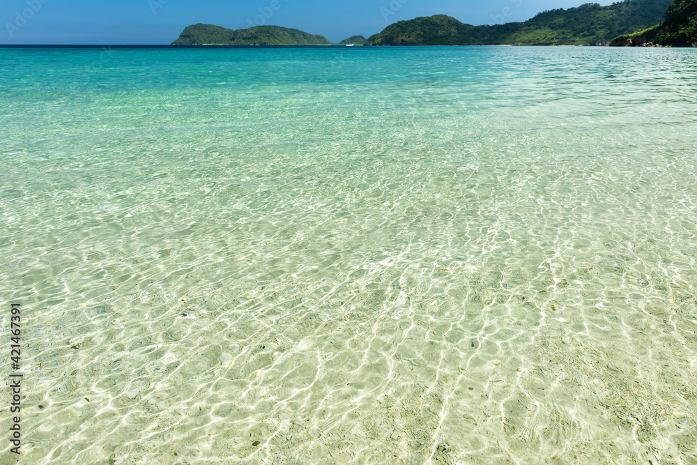 Crystal clear water and mountains make the perfect Iida beach backdrop for a swim. Iriomote Island.