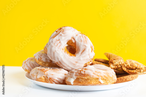 Sweet chocolate donut on yellow background. Dessert food