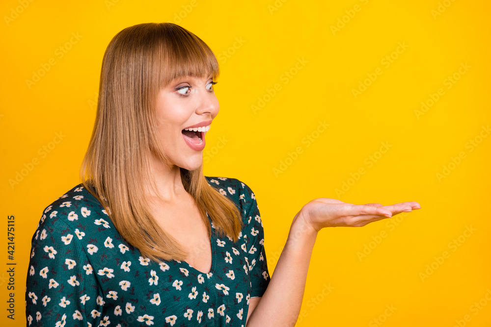 Photo of young woman excited surprised sale demonstrate product ad offer look empty space isolated over yellow color background Photo of young woman excited surprised sale demonstrate product ad offer look empty space isolated over yellow color background