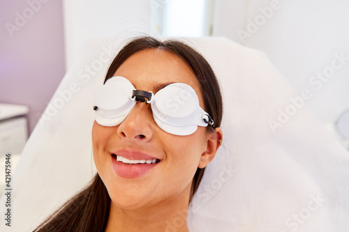 Patient with protective glasses before skin treatment