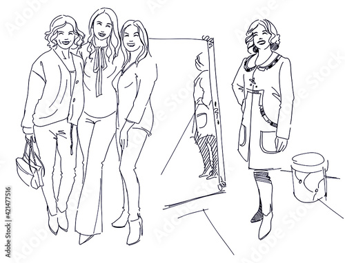 Women in the store try on fashionable clothes. The girl tries on a coat in front of a mirror. Girlfriends