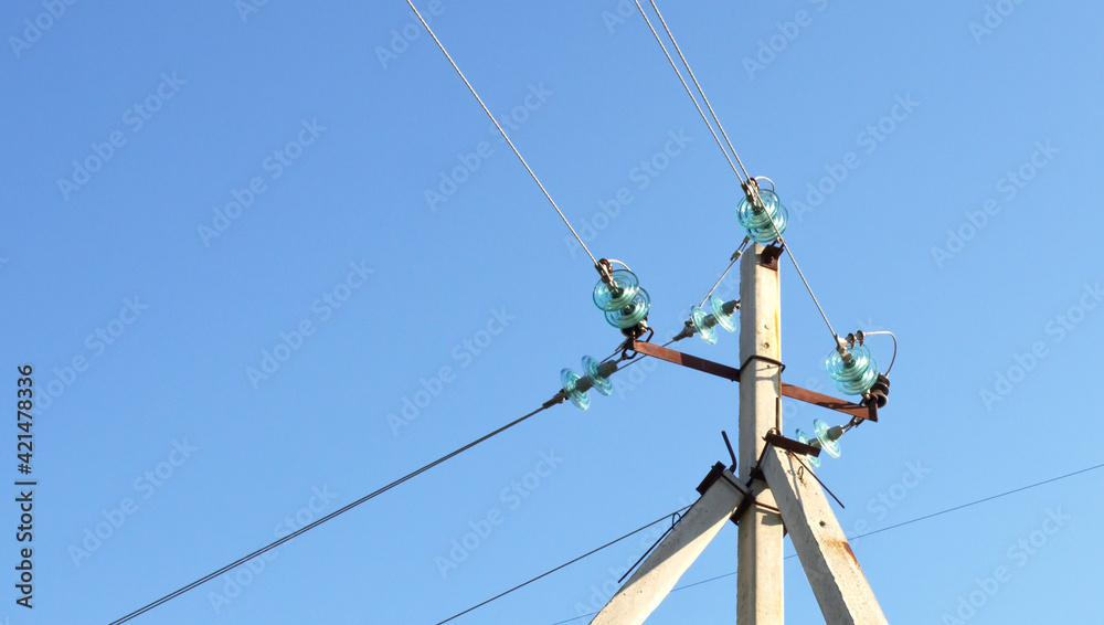 top of corner transmission tower of high voltage overhead power line. strain glass insulators, consists of assembly of suspension insulators, suspension strings, wires in closeup